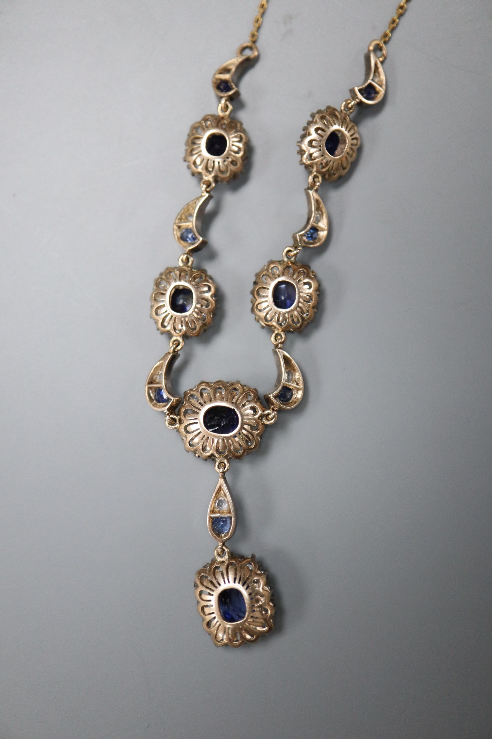 A Victorian yellow metal white and blue sapphire cluster set drop pendant necklace, approx. 80cm,